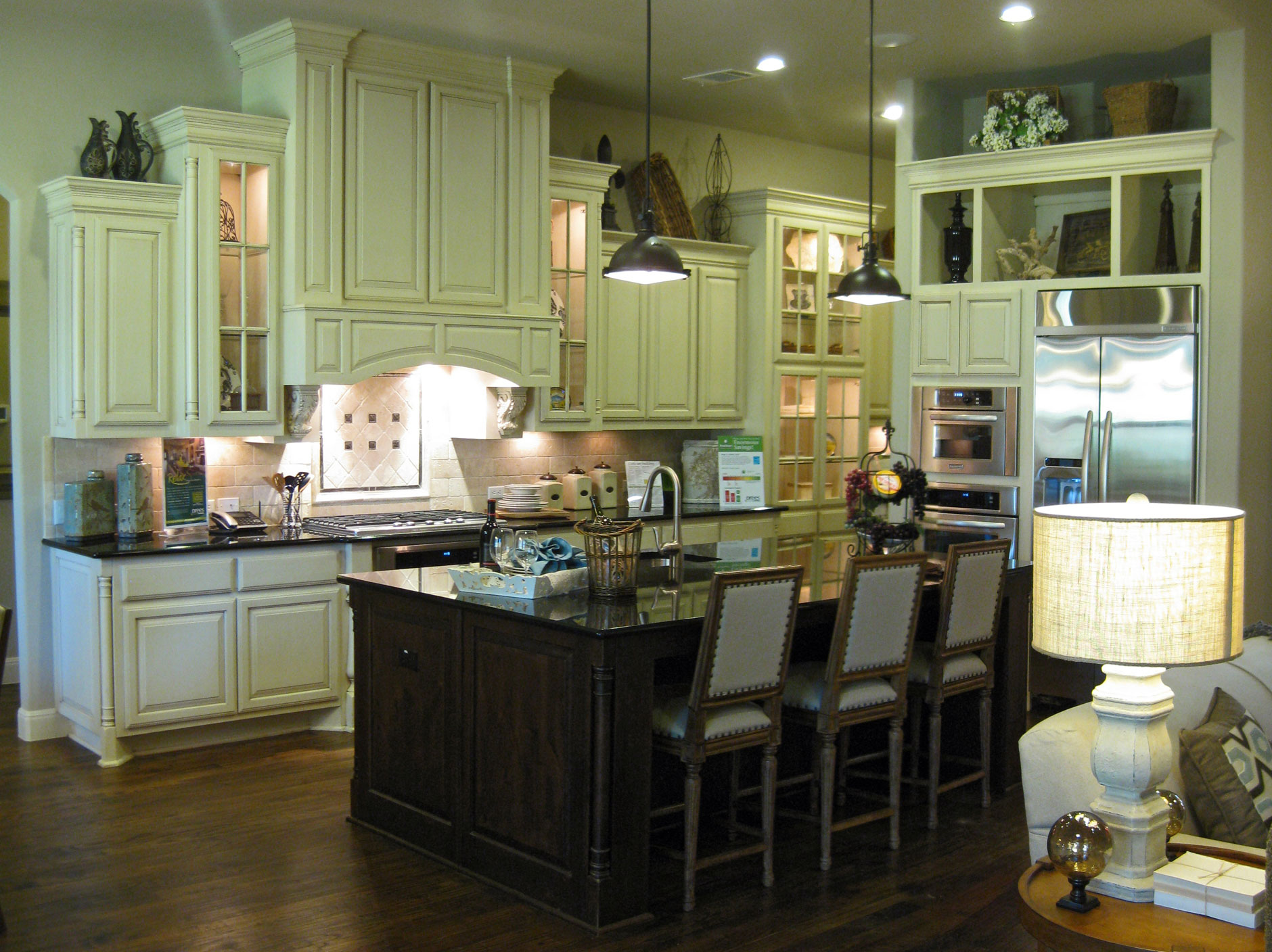 Burrows Cabinets kitchen cabinets with Elite vent hood in Bone with brown glaze
