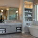 Burrows Cabinets modern gray bathroom vanity cabinets with SoCo doors and soaking tub