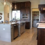 Burrows Cabinets kitchen cabinet 17 with Terrazzo doors in stain and grey painted island with posts
