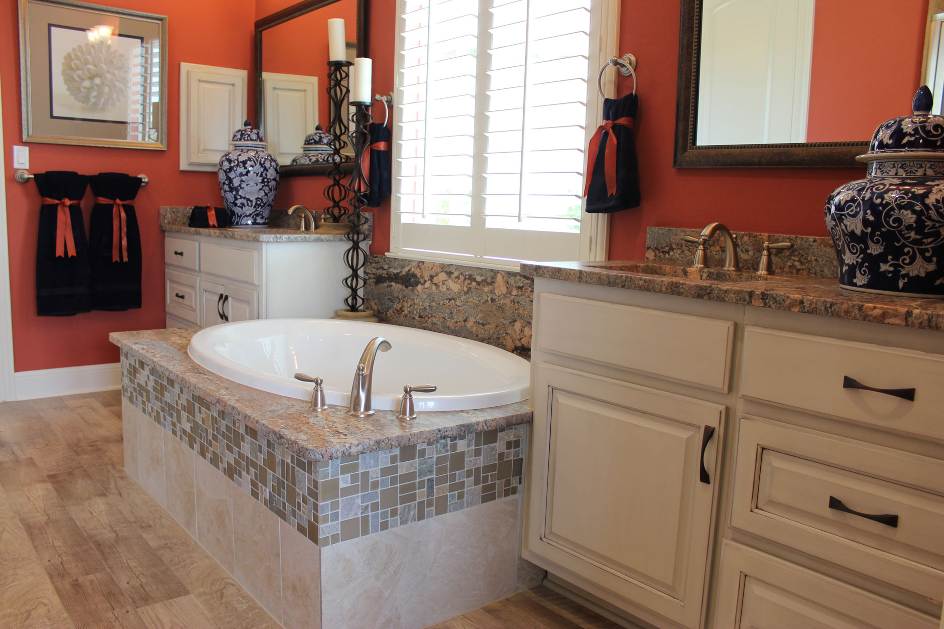 Primary bath with center tub and cabinets with raised panel doors by Burrows Cabinets