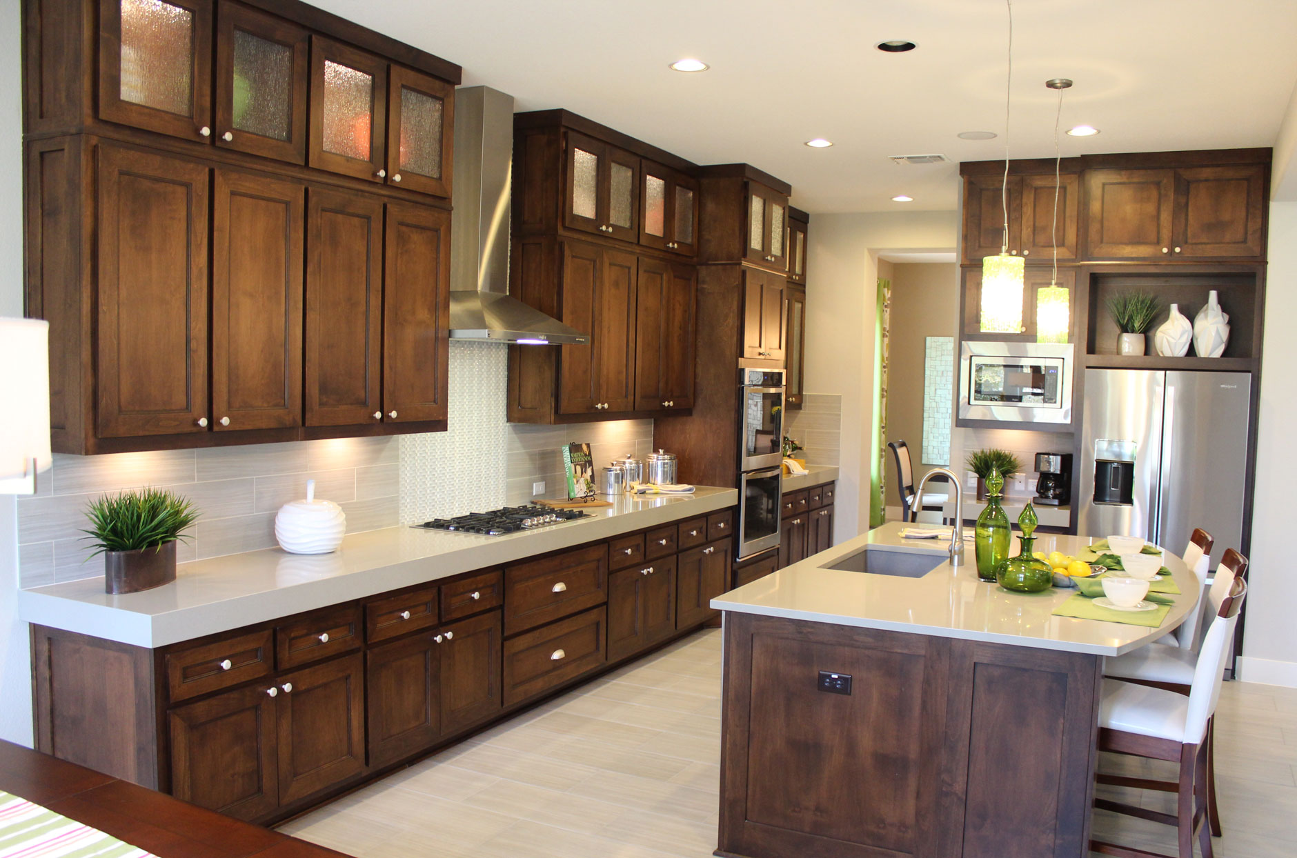 Kitchen cabinets by Burrows Cabinets with modern crown molding and Terrazzo doors