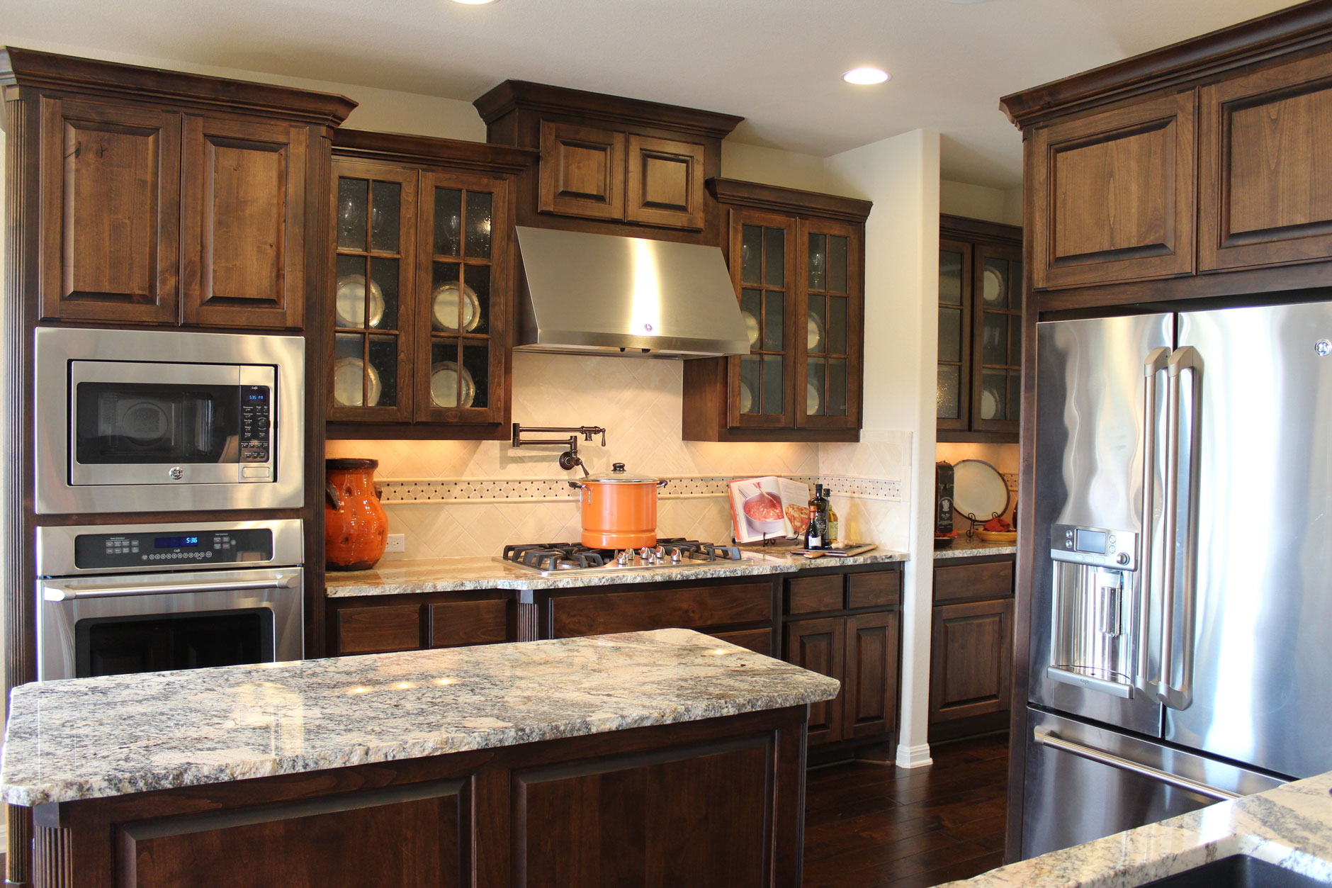 Burrows Cabinets kitchen in stained knotty alder and mullion doors with glass