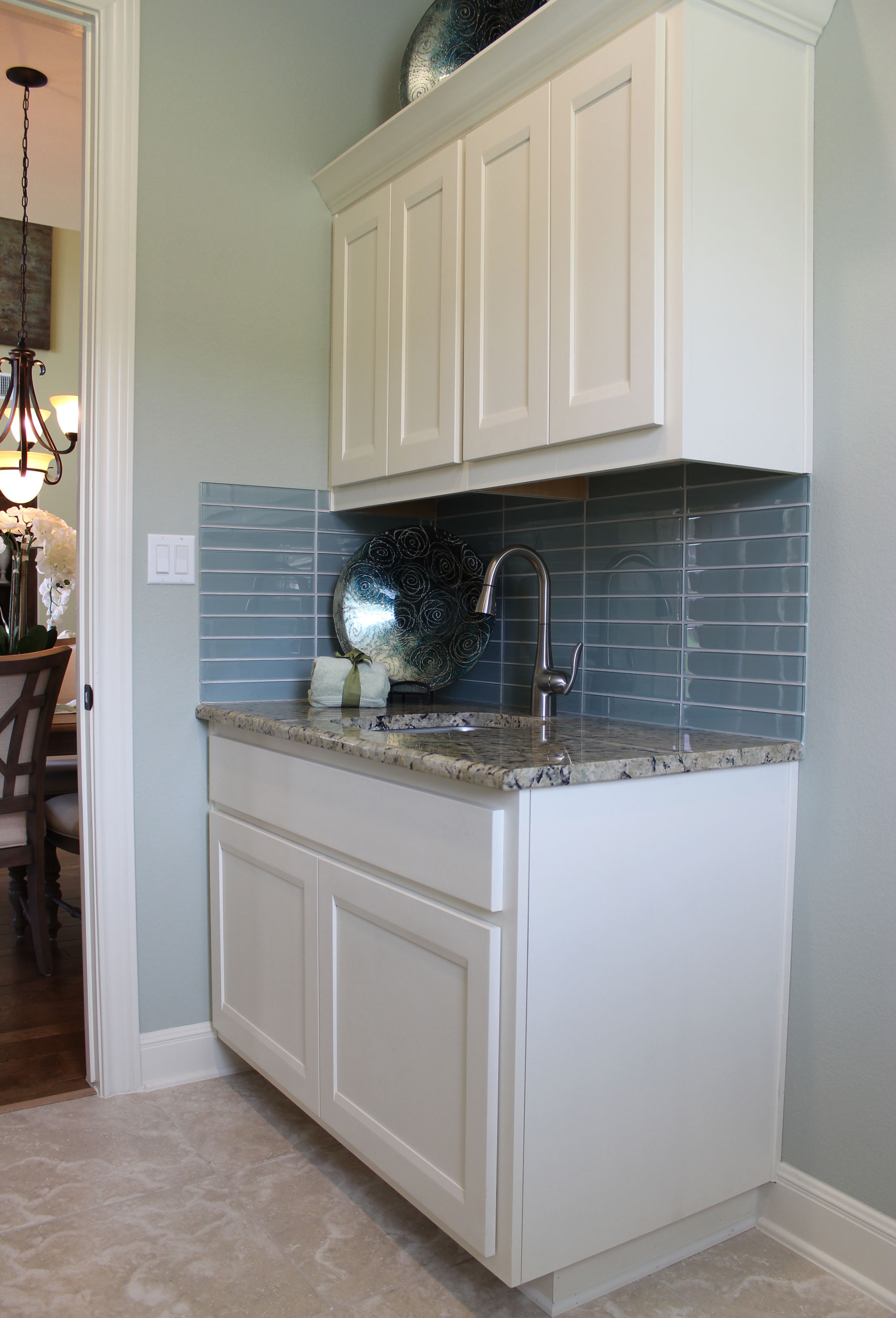 Laundry room cabinets in Bone with Briscoe doors by Burrows Cabinets