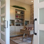 Burrows Cabinets' study with gray cabinets and sliding barn doors