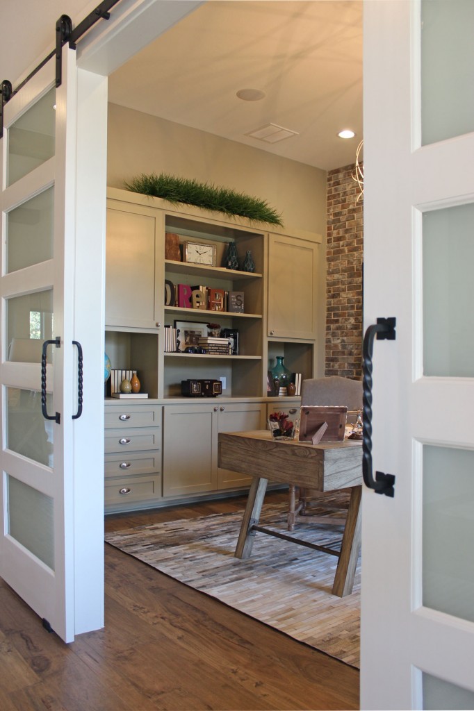 Burrows Cabinets' study with gray cabinets and sliding barn doors