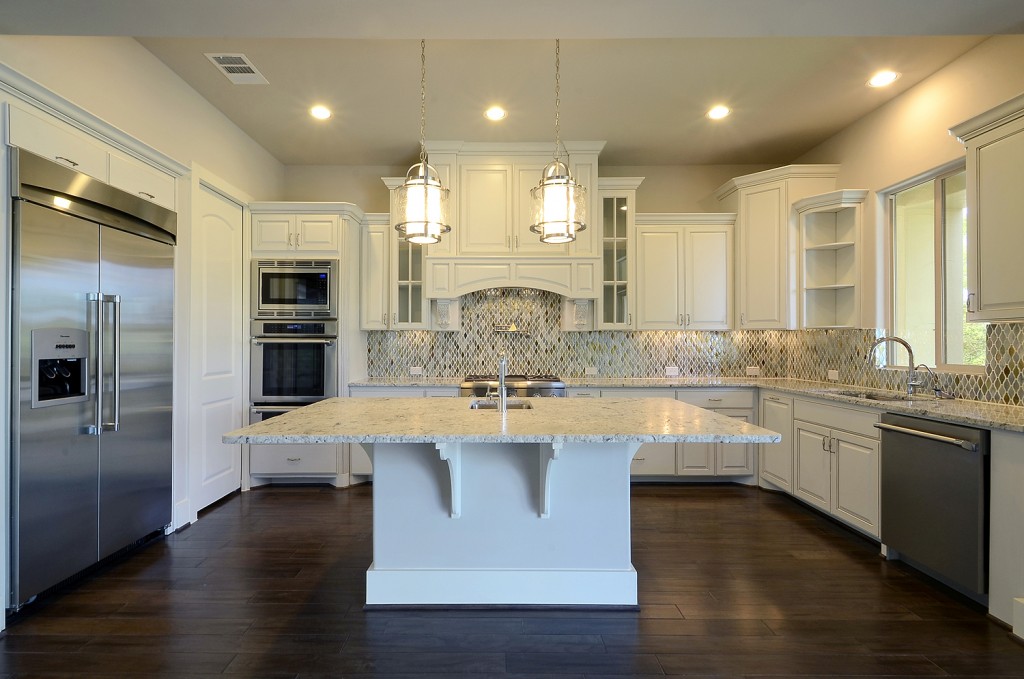 Burrows Cabinets white kitchen with glass doors, open shelves and bumped up cabinets
