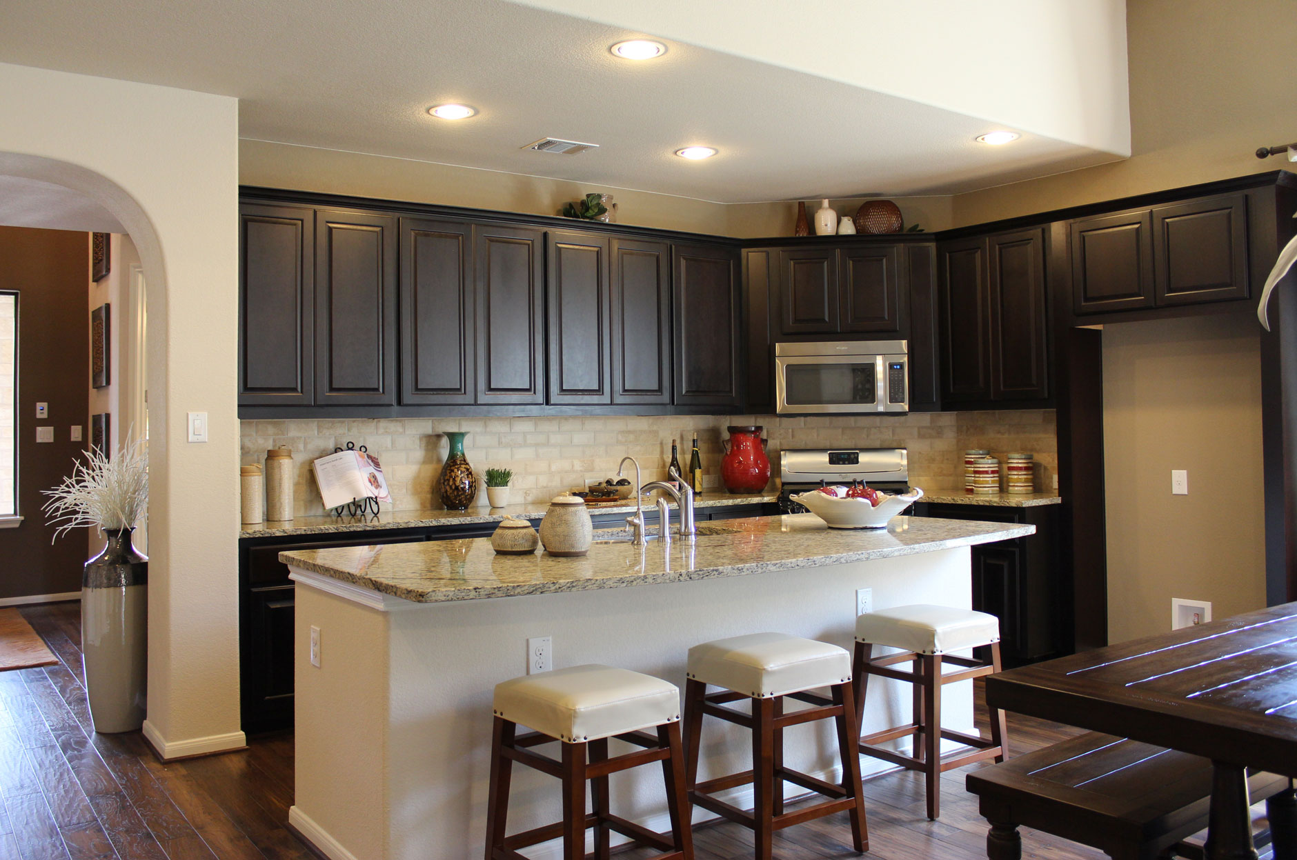 Dark brown kitchen cabinets by Burrows Cabinets in Espresso