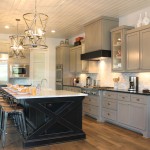 Burrows Cabinets kitchen with black island and gray wall cabinets and modern crown molding
