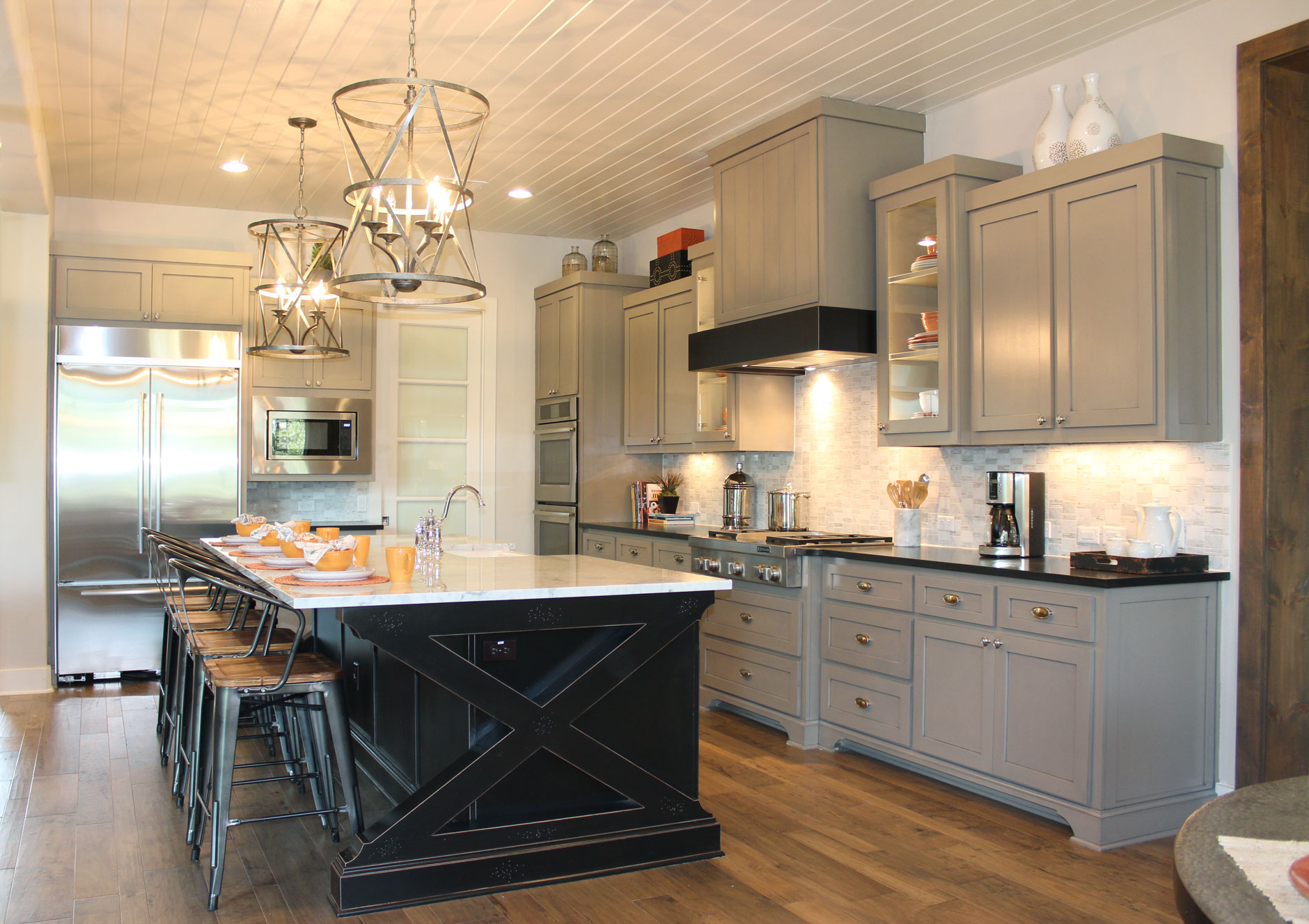 Burrows Cabinets kitchen with black island and gray wall cabinets and modern crown molding