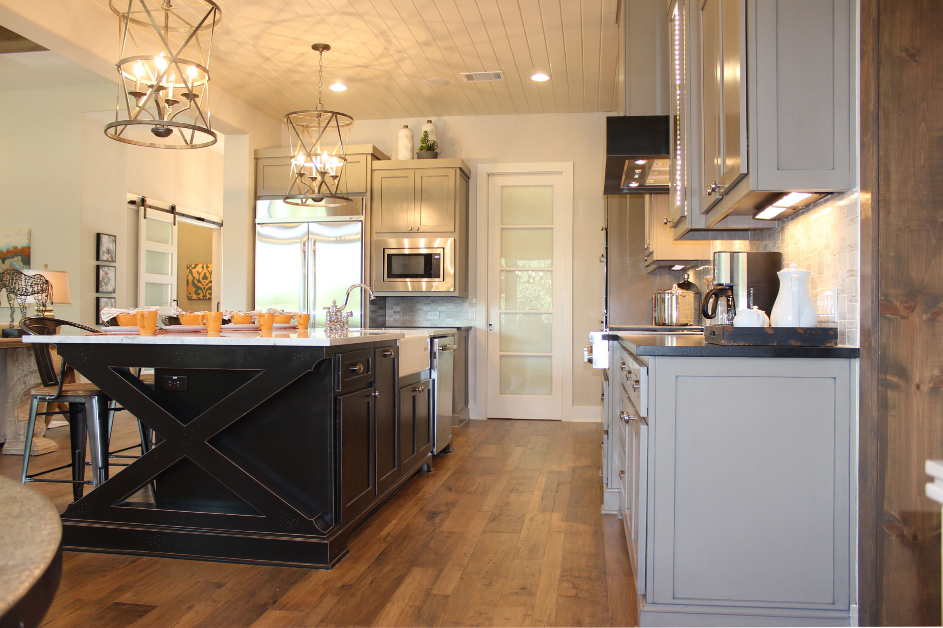 Burrows Cabinets Kitchen island with black x-brace and white farmhouse sink