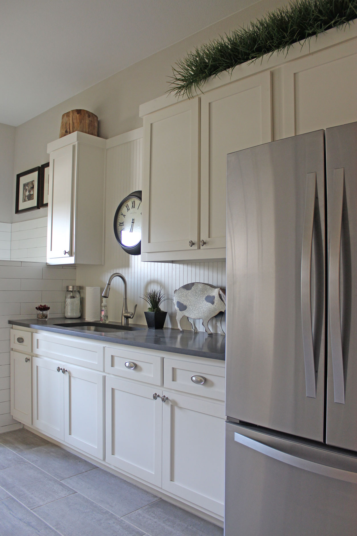 Burrows Cabinets laundry room with white beadboard backsplash