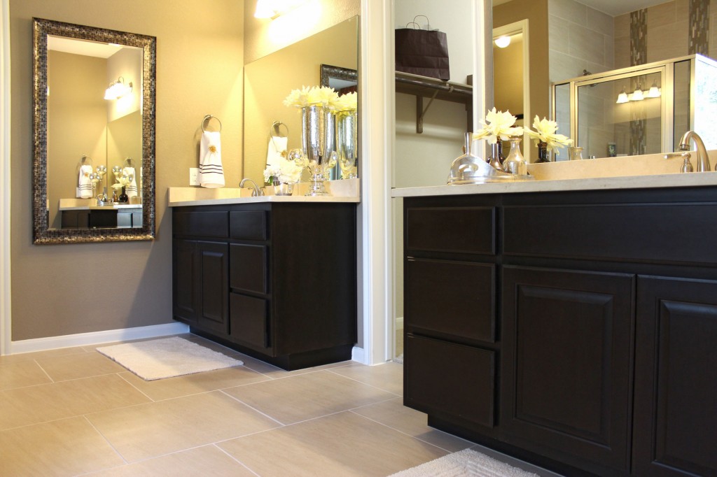 Primary bath with separate vanities by Burrows Cabinets in Espresso