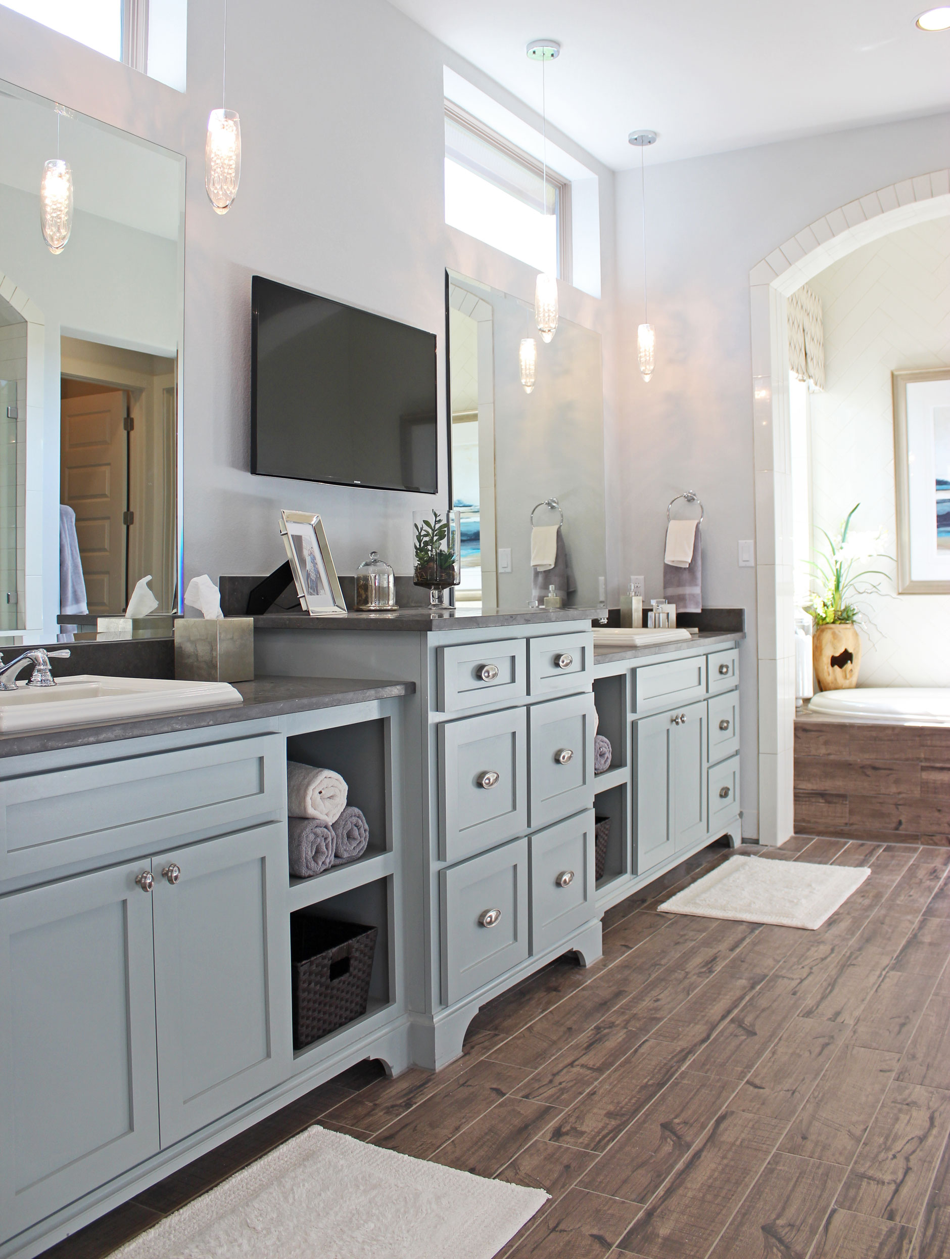 Burrows Cabinets shaker style primary bath cabinets with open shelves and bumped up drawer stacks