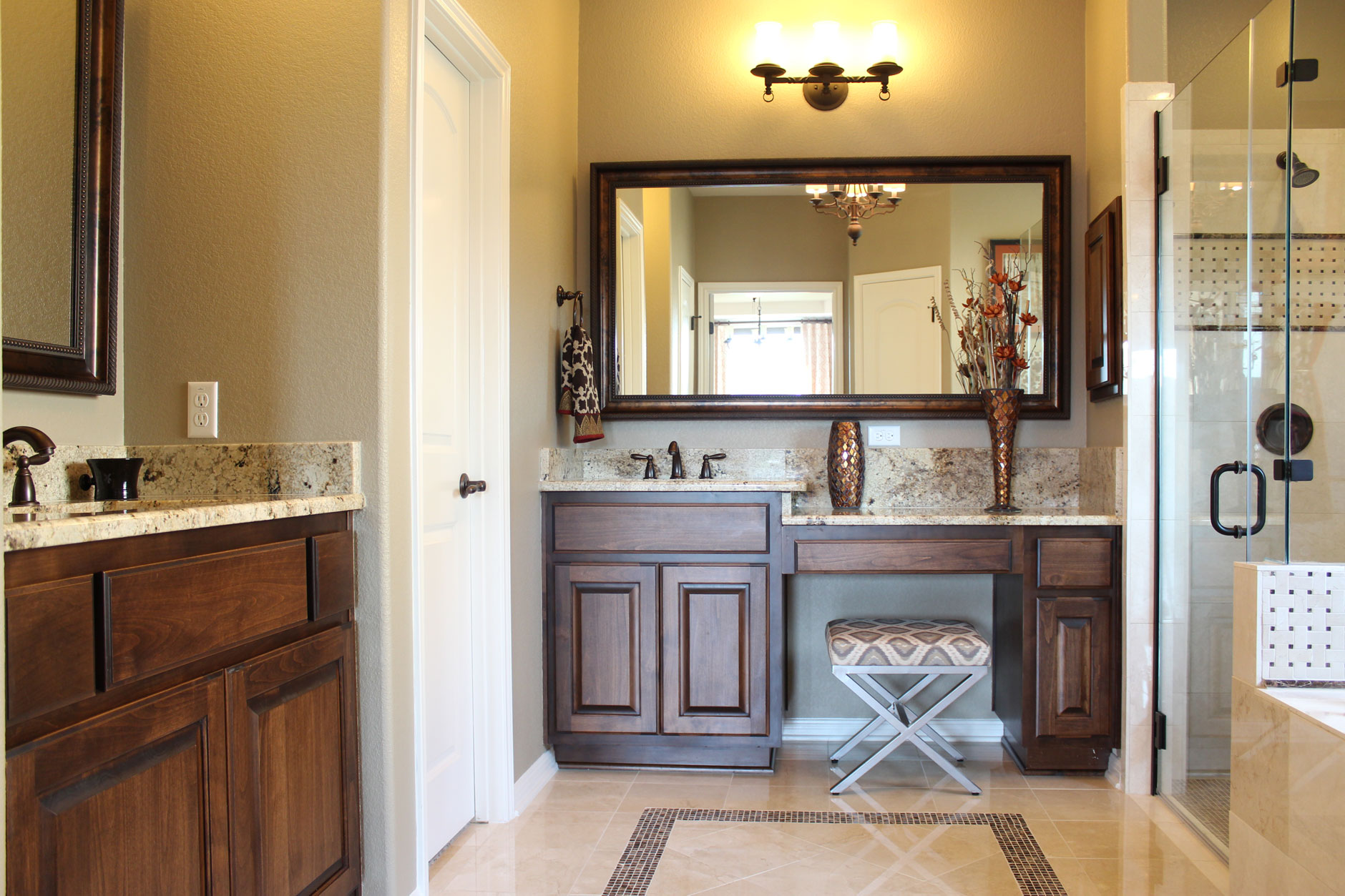 Burrows Cabinets primary bath vanity with knee space next to bumped up sink vanity