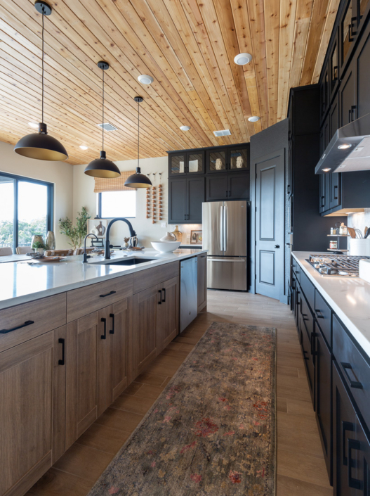 Reveur EVRGRN woodgrain kitchen island with 5pc doors and black perimeter cabinets