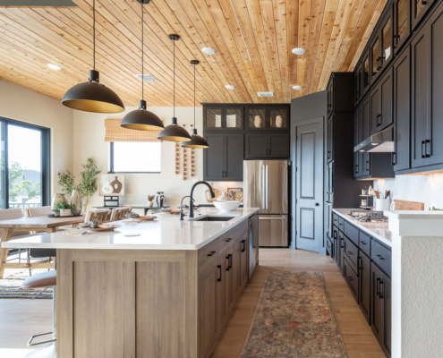 Kitchen with Breu soft black paint perimeter cabinets and Reveur woodgrain island cabinets