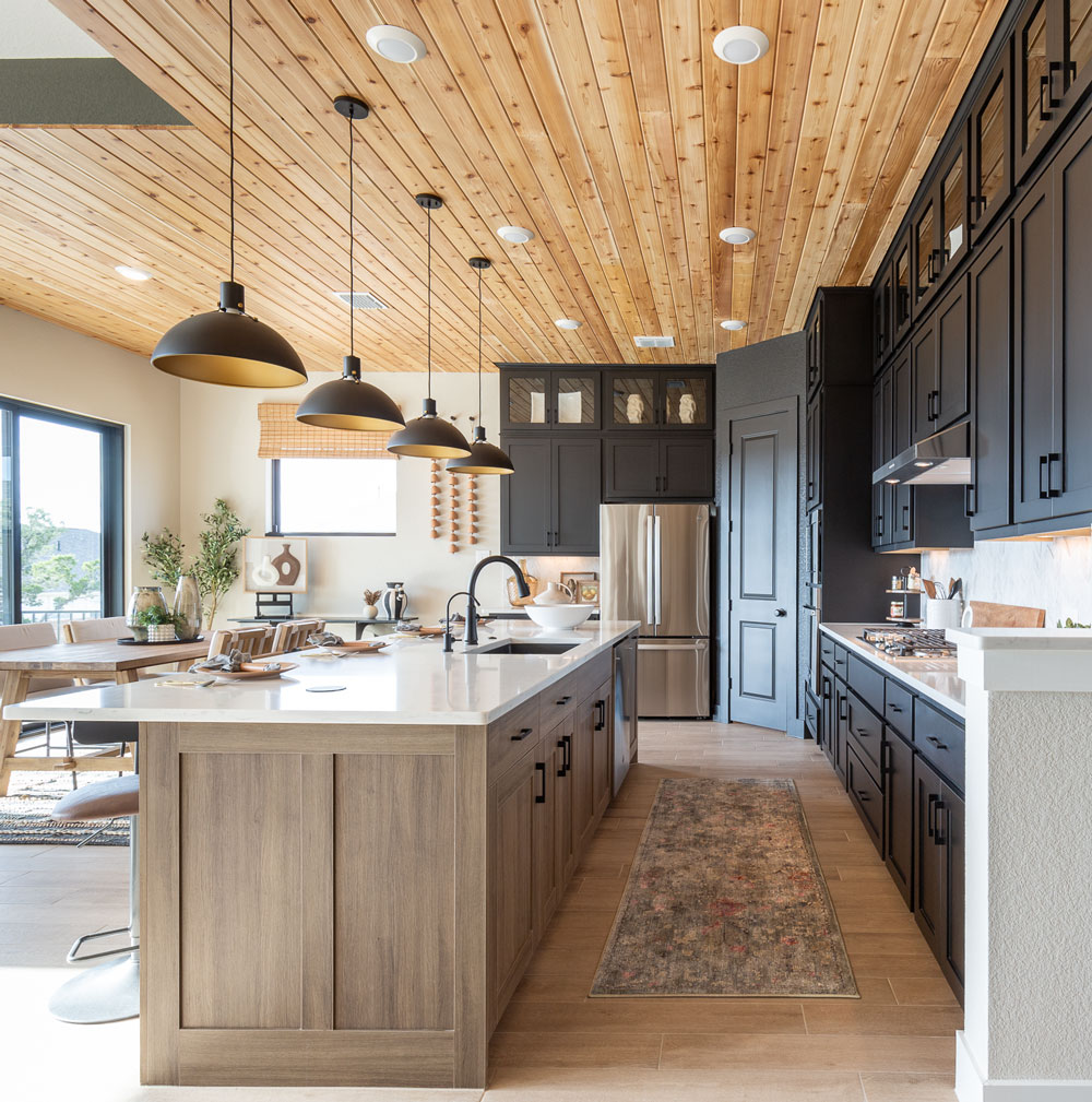 Kitchen with Breu soft black paint perimeter cabinets and Reveur woodgrain island cabinets