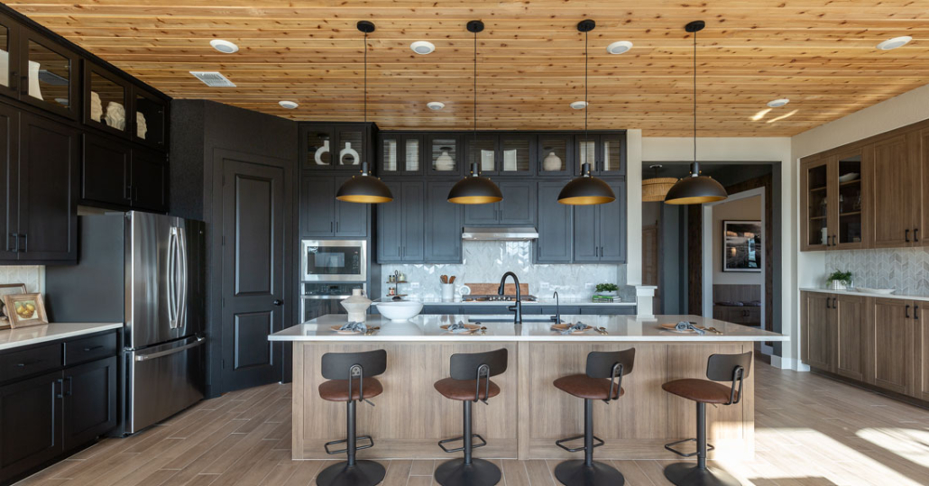 Kitchen with wood shiplap ceiling and Breu black perimeter cabinets and EVRGRN Reveur island and buffet