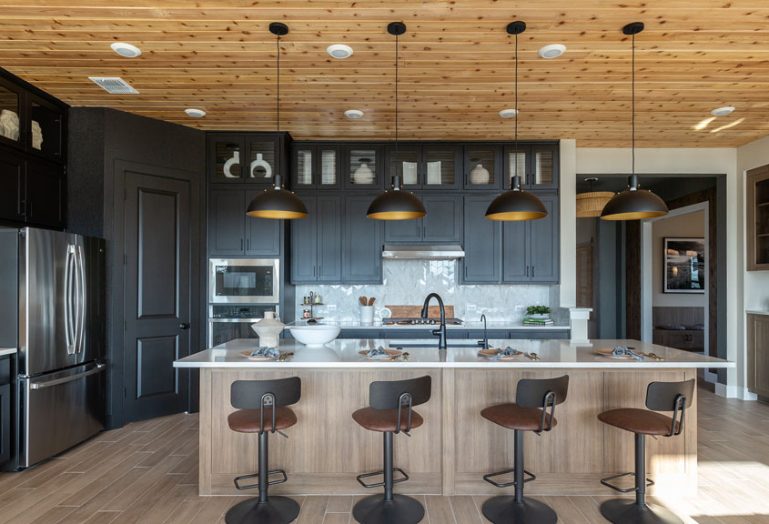 Kitchen with wood shiplap ceiling and Breu black perimeter cabinets and EVRGRN Reveur island and buffet