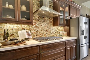 Burrows Cabinets' Beech wall cabinets in Kona stain with glass door inserts