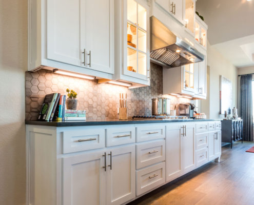Burrows Cabinets' kitchen with Shaker doors in Bone white and Dallas feet bumped up and out