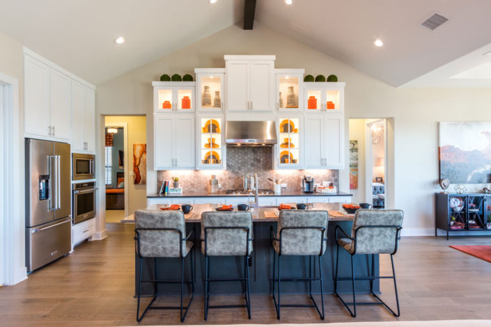 Burrows Cabinets' kitchen with orange accents, Shaker doors in Bone white and Dallas feet