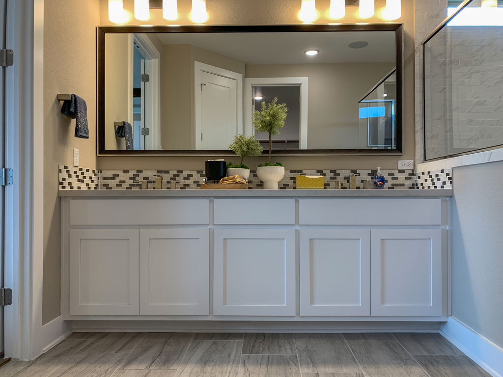 White bathroom vanity cabinets with Shaker doors by Burrows Cabinets