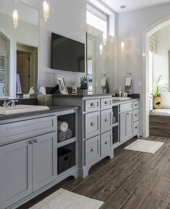 Primary bath cabinets Shaker light blue with open shelves and raised center drawer bank