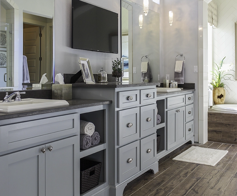 Primary bath cabinets Shaker light blue with open shelves and raised center drawer bank
