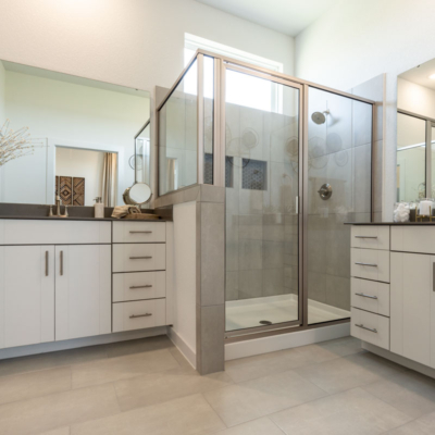 Bathroom in EVRGRN Luxe with dual vanities and 3pc doors