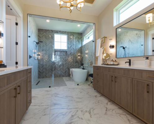 Bathroom vanity cabinets in Reveur medium woodgrain with slim shaker doors and enclosed soaking tub