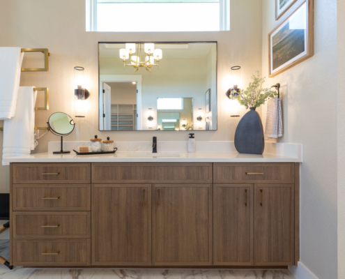 Bathroom vanity in medium woodgrain Reveur with Slim Shaker doors and gold pulls
