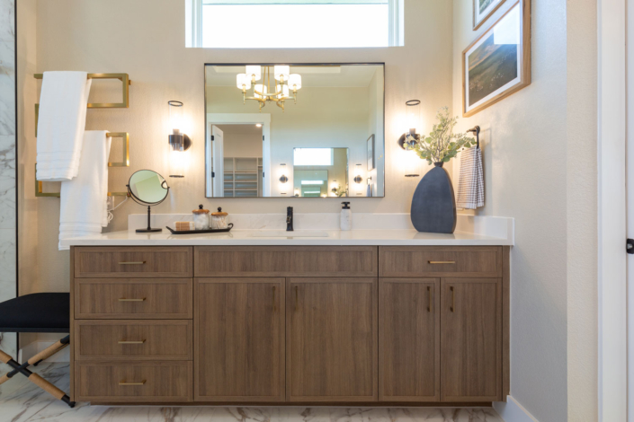 Bathroom vanity in medium woodgrain Reveur with Slim Shaker doors and gold pulls