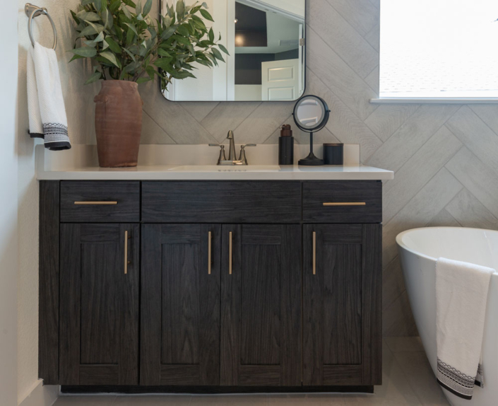 Bathroom vanity in dark grey woodgrain EVRGRN Vattern with 5pc doors Gold pulls freestanding tub