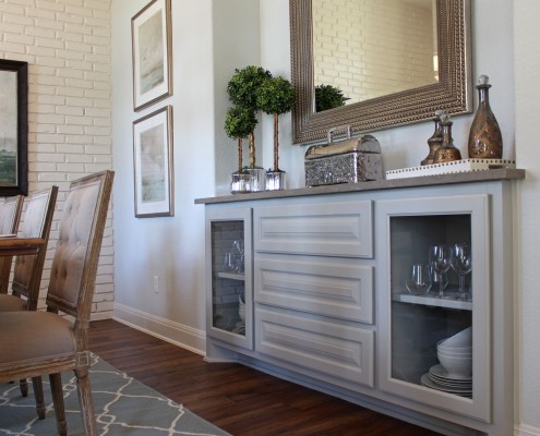 Burrows Cabinets built-in buffet cabinet painted gray with cabinet doors cut for glass inserts