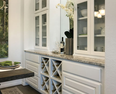 Burrows Cabinets' dining hutch in Frost featuring Big X wine rack, glass and raised panel doors