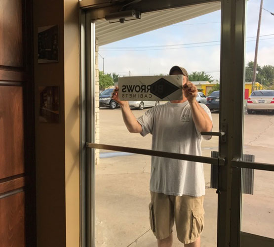 Burrows Cabinets door decal logo install in progress