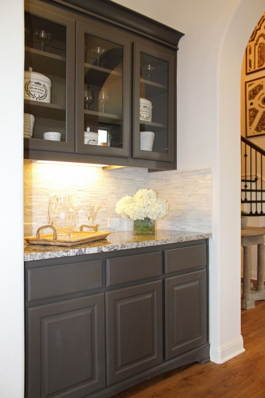 Butler's pantry with glass doors in upper cabinets in Umber gray paint