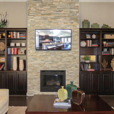 Family room with Burrows Cabinets' built in cabinets and bookshelves in Espresso