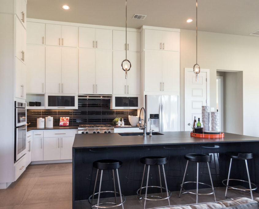 Burrows Cabinets' full overlay kitchen with modern white SoCo doors and black island