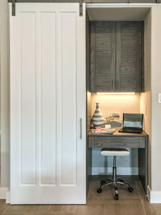 Barn door with hidden, built-in desk and cabinet in EVRGRN Rok
