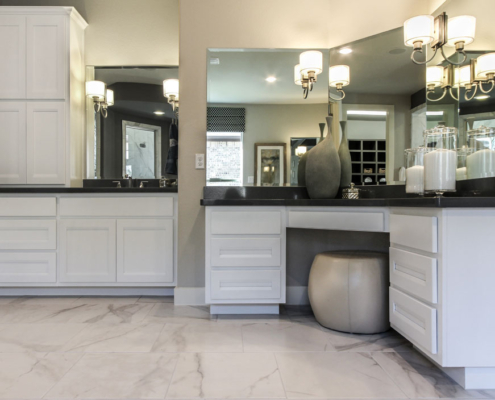 Burrows Cabinets' white bathroom cabinets with separate vanities and tall linen storage