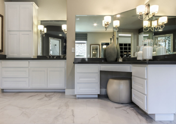Burrows Cabinets' white bathroom cabinets with separate vanities and tall linen storage
