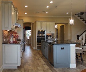 Burrows Cabinets kitchen with Ash gray island and perimeter cabinets in bone with black glaze