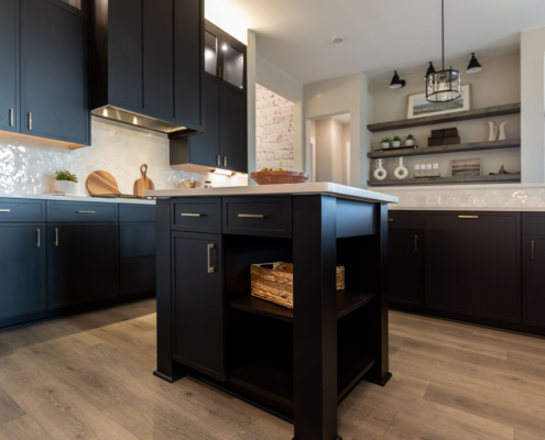 Kitchen island in Breu black paint with Slim Shaker doors and gold pulls