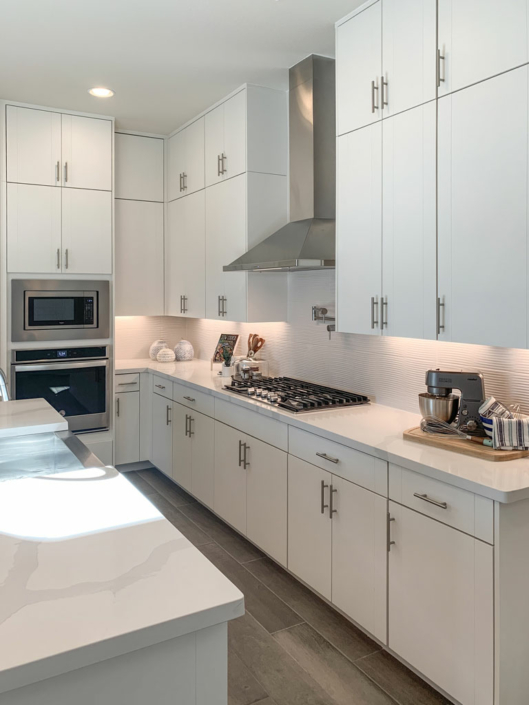 Kitchen interior view in EVRGRN Luxe textured white with 3-piece doors