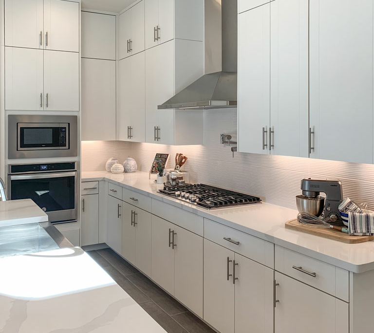 Kitchen interior view in EVRGRN Luxe textured white with 3-piece doors