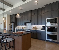Kitchen in Greystone perimeter cabinets with Beech Bali stained island