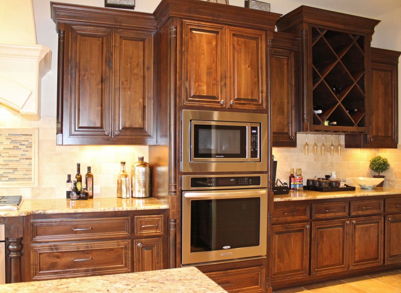 Burrows Cabinets' knotty alder cabinets with big x wine rack
