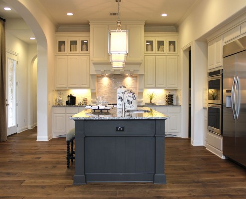 Burrows Cabinets' kitchen cabinets in bone white with umber gray island